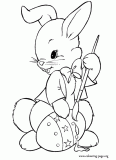 Easter bunny decorating Easter egg coloring page
