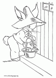 Easter bunny handing Easter eggs coloring page